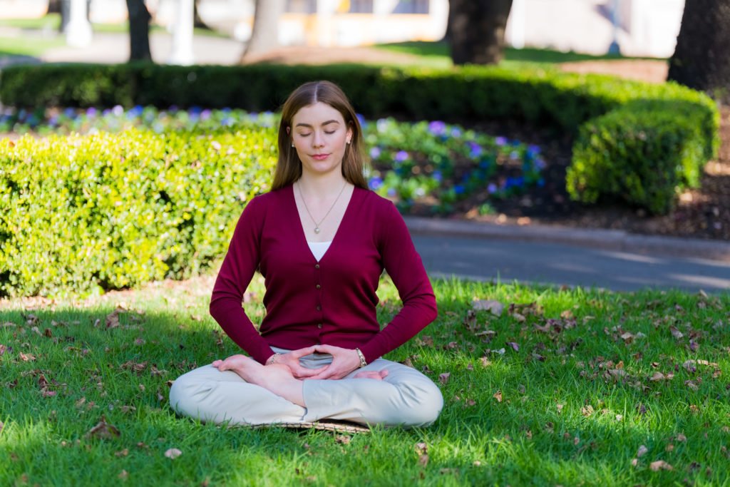 a meditator sitting along in the park